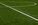 Photo of a green synthetic grass sports field with white line shot from above